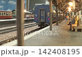 An old-style passenger express train runs on a model railway layout. 142408195