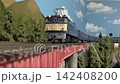 An old-style passenger express train runs on a model railway layout. 142408200