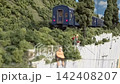An old-style passenger express train runs on a model railway layout. 142408207