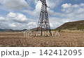 Dry grass plains and rolling hills beneath cloudy sky 142412095