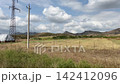 Rural farmland with hay bales and power lines in slow motion 142412096