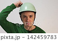 Man in helmet checking safety and durability 142459783