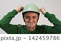 Young cyclist wearing a safety helmet smiling 142459786