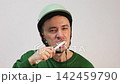 Funny male biker wearing a protective helmet  142459790