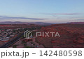 Aerial view of red rock cliffs and St George city at sunrise in Utah 142480598