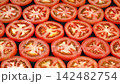 Dolly shot of fresh ripe red tomatoes arranged in rows on black background, organic healthy raw vegetable ingredient 142482754