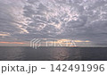 A live-action video footage of a sky covered with thick clouds and the light of the sunrise peeking over the horizon, available for commercial use. A live-action video footage of a sky covered with thick clouds and the light of the sunrise peeking over the horizon, available for commercial use. 142491996