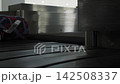Suitcases moving around on baggage conveyor at an airport, travel, 4k 142508337