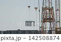 Yellow tower cranes at a construction site of a modern building 142508874