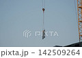 High-rise apartment building under construction with crane 142509264