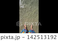 Bare Feet Walking Into Sea Waves 142513192