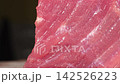 Macro dolly shot revealing raw beef steak muscle fibers and meat grain texture, fresh red tenderloin culinary ingredient 142526223