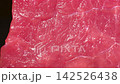 Extreme macro dolly shot gliding over fresh raw beef steak showing glistening muscle fiber texture and juicy red meat details 142526438