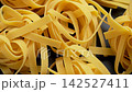 Many Italian fettuccine pasta nests close up with organic healthy natural ingredients. Rotation 142527411