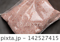 Himalayan salt packed in plastic transparent packaging. Supermarket product. Top view. Rotation 142527415