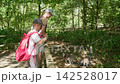 A boy and a girl are feeding the lemurs slow motion 142528017