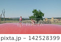 Kids are jumping on a trampoline outdoors slow motion 142528399