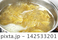 Boiling pasta in a saucepan. Whole wheat Farfalle, bow-tie or butterfly pasta Cooking in a pot with Steaming boiling water. Preparing Italian dish. Pan on a stove. High angle view. Slow Motion footage 142533201