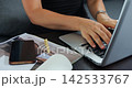 People managing social media tasks. Relaxed office environment with digital planning and coffee. Workers engaged in social media coordination and scheduling within casual office setup 142533767