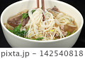 Stirring hot Vietnamese beef pho noodle soup with wooden chopsticks, traditional culinary street food preparation 142540818