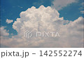 White puffy clouds drifting across a bright blue sky during a sunny afternoon capturing nature in motion 142552274