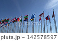The flags of various countries fluttering in the wind under the blue sky, symbolizing international exchange and global cooperation. 142578597