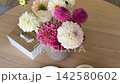 Raspberry dessert beside a beautiful peony bouquet with coffee on a wooden table, elegant food styling, sweet berry treat and cozy cafe setting for a refined meal 142580602
