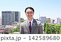 A businessman turns around from behind and smiles. 142589680