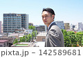 A businessman turns around from behind, his face serious. 142589681