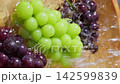 Vertical video: Washing Shine Muscat and Kyoho grapes under running water 142599839
