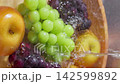 Vertical video: Washing grapes and pears in a bucket 142599892
