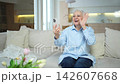 Happy middle aged senior woman talking with smartphone on video call with friends family. Laughing mature old senior lady grandmother having fun talking speaking with grown up children online 142607668