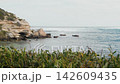Coastal landscape featuring rocky cliffs and blue ocean waves 142609435