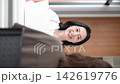 A vertical video showing a clinic image featuring a female doctor smiling and explaining medical counseling, examinations, and health consultations to patients. 142619776