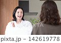 A clinic image video featuring a female doctor smiling and explaining medical counseling, examinations, and health consultations to patients. 142619778