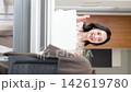 A vertical video showing a clinic image featuring a female doctor smiling and explaining medical counseling, examinations, and health consultations to patients. 142619780