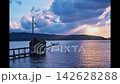 A quintessential scene of Lake Togo bathed in crepuscular rays: a four-pronged fishing net. 142628288