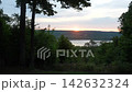 A time-lapse video of the sunrise over the lake and trees. 142632324