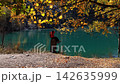 Hiker admiring the beautiful autumn Issyk lake scenery, Kazakhstan 142635999