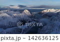 Aerial view flying over snowy lofoten mountain peaks and fjord, Norway 142636125