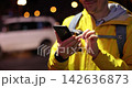 Excitement builds as a man shares moments on his phone during a vibrant night out 142636873