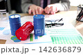 Creative brainstorming at the office with colorful containers and graphs on the table 142636879