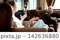 Engaging conversation unfolds in cozy living room setting during afternoon 142636880