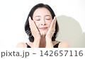 [Slow motion] A 50-year-old woman with beautiful skin looks directly at the beauty camera, touching her cheek in a skincare image. 142657116