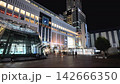 Nighttime cityscape of Sapporo Station area featuring bright neon commercial buildings and passing traffic on a summer night in Hokkaido, Japan 142666350