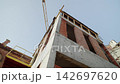 Brick and concrete unfinished building and high tower crane 142697620