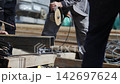 Worker uses disk saw to cut beam edge at construction site 142697624
