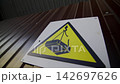 Danger overhead crane load falling hazard risk sign on fence 142697626
