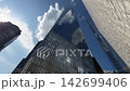 Airliner flies past Freedom Tower on sunny day looking up NYC 142699406