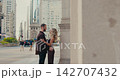 Romantic couple embracing on a busy city street 142707432